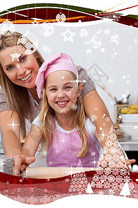 母亲和女儿在厨房里烤圣诞饼干 在厨房里做蛋糕 坠落 庆祝图片