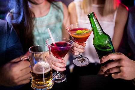 一群朋友在酒吧柜台烤鸡尾酒 啤酒瓶和啤酒杯 周末 女性图片