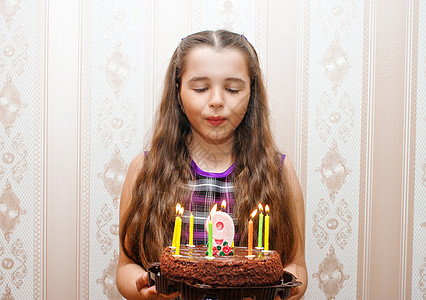小女孩在蛋糕上吹蜡烛了图片