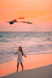 小姑娘在海滩上放风筝 喝松松水 美丽的 孩子 女孩图片