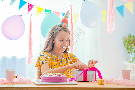 白种女孩梦寐以求地笑着看生日彩虹蛋糕 喜悦的多彩背景与气球 生日派对和祝愿概念 五彩纸屑 朋友们图片