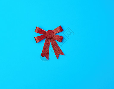 蓝色背景的装饰礼物红闪亮的礼弓图片
