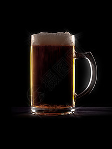 黑色背景玻璃杯中的典型啤酒背景图片