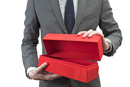 商人拿着一个红色礼品箱 孤立在白色背景 套装图片