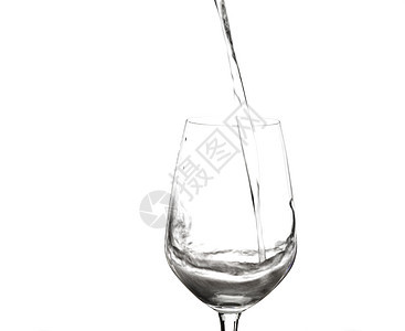 在葡萄酒杯中喷洒的水 孤立在白色上图片
