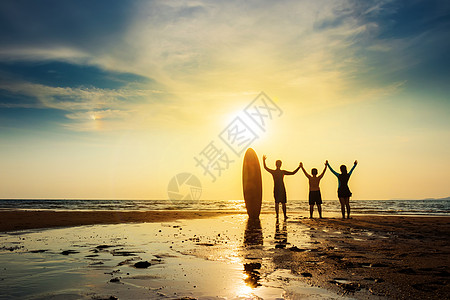 冲浪人快乐朋友团体的轮廓与冲浪板站在一起 张开双臂 在日落海滩冲浪 户外水上运动冒险生活方式 夏季活动 友谊 檀香山图片