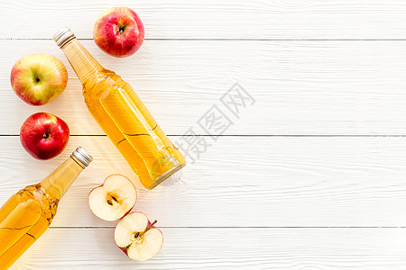 白色桌面上自上而下文字空间上的苹果苹果苹果醋醋瓶 躺着 发酵的图片