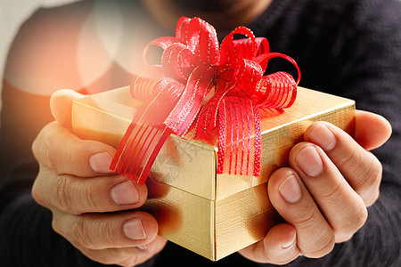 男子手拿着礼物盒作为赠与的表示 b 红色的 圣诞节图片