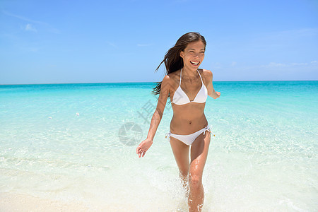 欢快的女子在海滩奔跑图片