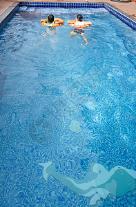 母亲和孩子在度假村游泳池游泳 以获得f图片