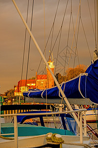 波兰乌斯特卡渔业港乌斯特卡 旧灯塔在温暖的日边 风景优美的 船图片
