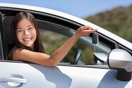 新车司机女人拿着旅行公路旅行的钥匙 在经销商处租赁或购买汽车的快乐亚洲年轻女孩图片