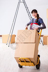 在搬迁概念中 妇女承包商搬运箱件 贮存 推车图片
