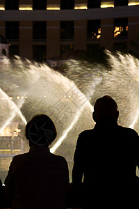 在拉斯维加斯欣赏贝拉吉奥喷泉奇观的人们剪影的夜景 晚上 城市天际线图片
