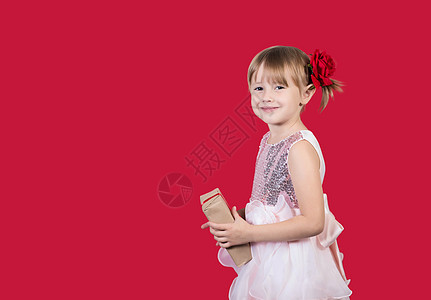 可爱可爱的笑笑女孩 带着圣诞礼物 在红色上被孤立 美丽 惊喜图片