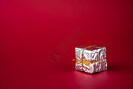 红色背景的银色假日礼物盒 复制空间图片