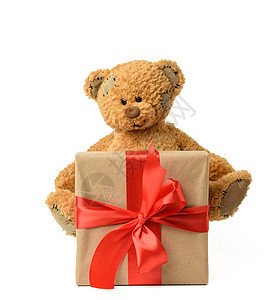 棕褐色可爱泰迪熊 旁边的盒子与礼物 绑着红色丝带图片