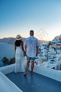 希腊圣托里尼 欧洲和亚洲中年年轻夫妇在希腊伊亚圣托里尼村度假 豪华度假圣托里尼 快乐 火山图片