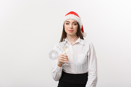 圣诞节庆祝活动-年轻美丽的商务女士用一杯香槟庆祝圣诞节 商业 工作室图片