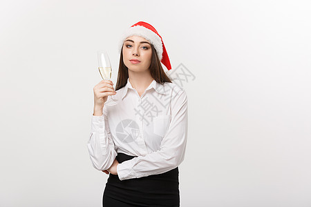 圣诞节庆祝活动-年轻美丽的商务女士用一杯香槟庆祝圣诞节 派对 裙子图片