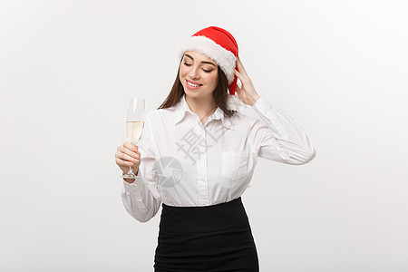 圣诞节庆祝活动-年轻美丽的商务女士用一杯香槟庆祝圣诞节 香槟酒 吐司图片
