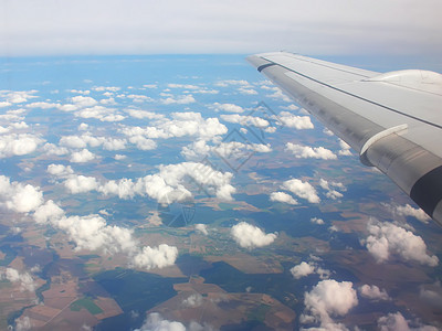 从飞机窗口看到 白云在陆地上空 旅行 地平线 空气图片