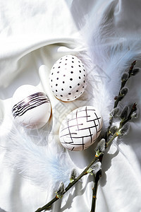 时髦的彩色时尚天然复活节彩蛋 羽毛 白色丝绸质朴布上的褪色柳枝 平躺 复活节静物 庆典 亚麻布图片