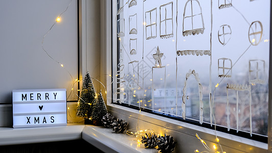 窗台上带有文字“圣诞快乐”的灯箱 新年装饰花环灯和圣诞树 窗户喷雪 快乐的 装饰风格图片