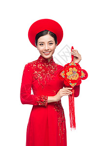 春节出行一位美丽的亚洲妇女穿着传统节服Ao Dai Tet节日 月经新年的肖像 微笑 女士背景