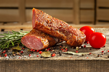 烟熏肉 在木制桌上切碎的熏牛肉 加上新鲜草药和香味香料图片