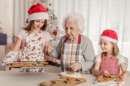 外婆 外孙女和外孙女一起烤饼干 圣诞节 圣诞帽 烹饪图片