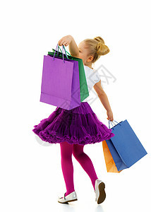 手里拿着多色袋的小女孩 笑声 购物者 购物狂图片