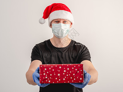 在科罗纳病毒流行期间 一个信使在圣诞节运送包裹图片