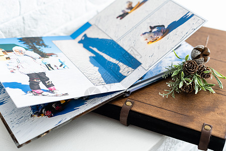 豪华木制相册 印有夏季照片的木盒和亚麻自然背景上的闪存卡 家庭回忆写真集 保存您的暑假回忆 木质封面相册 书图片