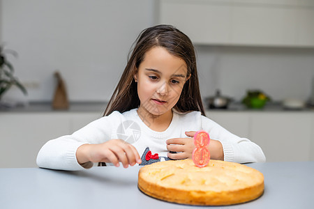 女孩在生日与蛋糕和蜡烛 微笑 锥体 庆典 孩子 闭上眼睛图片