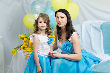 妈妈和女儿在沙发上 带着一束花 幸福 展示 假期图片
