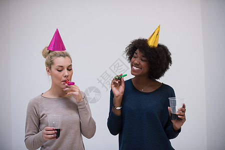 微笑着的女子在党帽上吹响口哨 幸福 生日 鼓风机图片