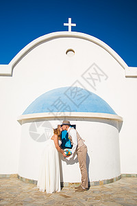 有趣的美丽新娘和新郎 有教堂在背景上的背景 希腊 夏天图片
