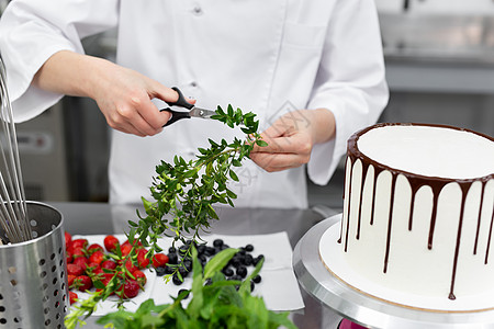 糕点厨师准备装饰蛋糕的草药图片