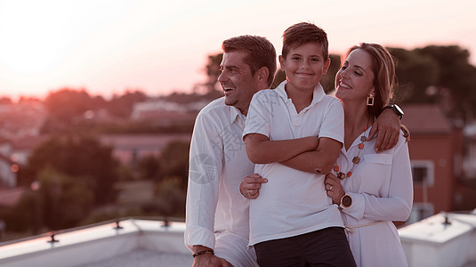 幸福的家庭享受和共度时间在房顶上 有选择地集中关注 日落 快乐图片
