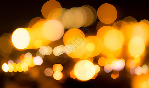 模糊的黄色散景背景 模糊城市光的抽象背景 温暖的光线与美丽的圆形散景图案 夜里的橙色灯光 街灯在夜间模糊了城市的灯光图片