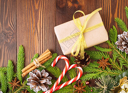 圣诞节和新年快乐的背景 礼品圣诞牛皮纸盒 冷杉树枝 锥体 肉桂 木桌图片