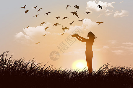 夕阳下草地上放飞鸽子的女人背景图片