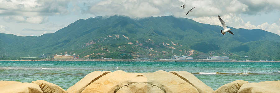 岩石沙滩大海背景设计图片