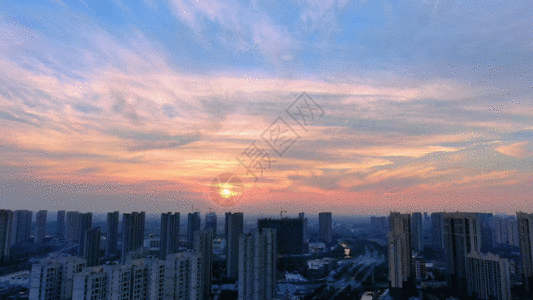 夕阳下城市美丽晚霞航拍城市建筑GIF高清图片