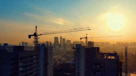 清晨的太阳航拍城市建设剪影GIF高清图片