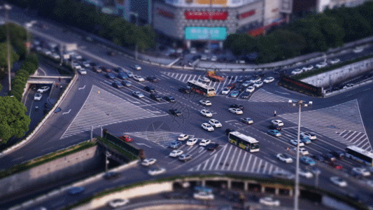 夜空下的建筑实拍微缩城市十字路口高架桥日转夜GIF高清图片