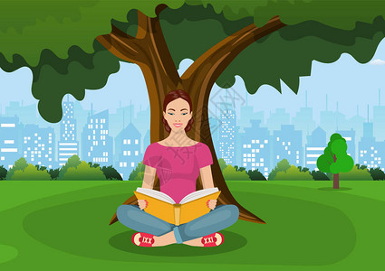 年轻女在城市公园的一棵树下阅读书籍教育阅读学习以平板方式图片