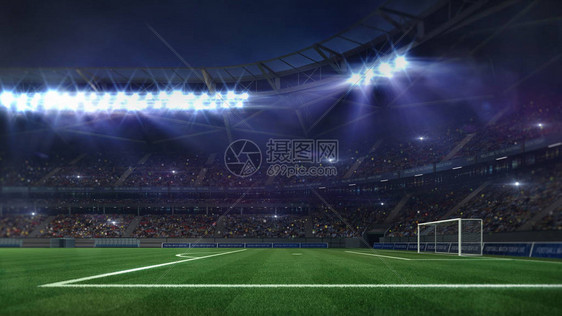 由聚光灯和空旷的绿草场照亮的大型足球场图片