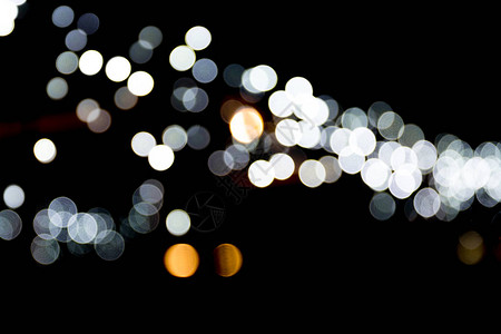 白色城市灯光在黑色背景上的抽象布基赫焦点分散图片